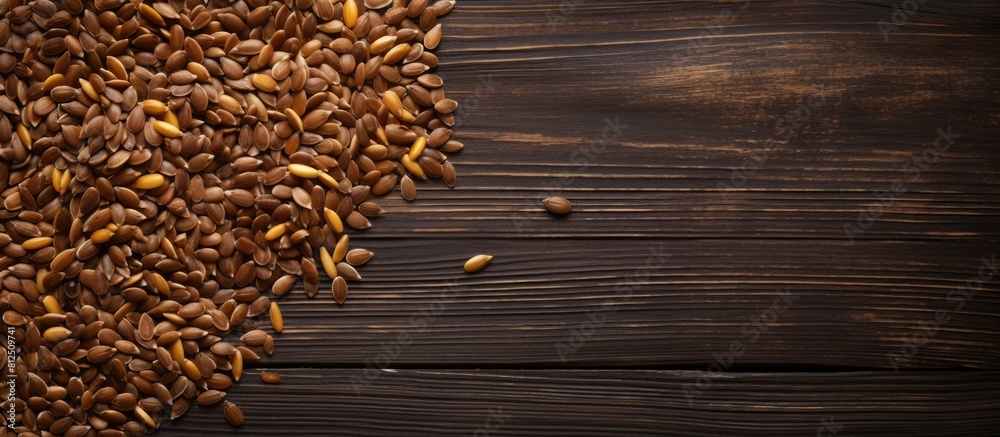 Aufkleber A top down view of golden and brown flax seeds on a dark wooden surface creating a visually appealing copy space image