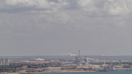 Fototapeta premium Thermoelectric Power Plant with smoking pipes aerial timelapse.