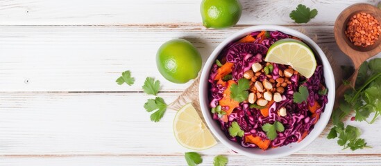 Top view of a detox salad made with red cabbage carrots and pomegranate accompanied by a flavorful cilantro dressing Presented on a white wooden background with ample space for copy - Powered by Adobe