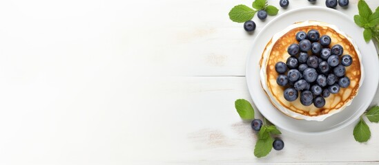 Top view of a copy space image featuring light background with cottage cheese pancakes sour cream and blueberries Suitable for breakfast or lunch