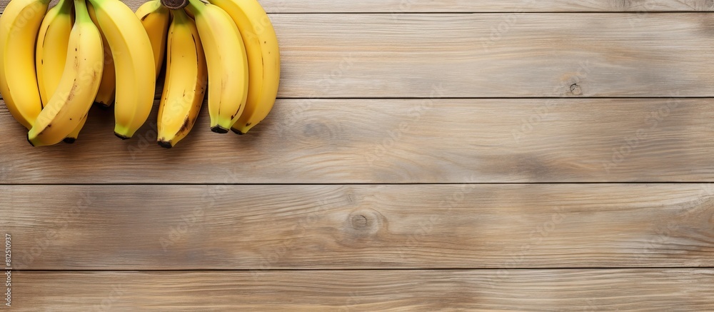 Aufkleber A top view of three ripe bananas placed on a light wooden background leaving empty space for additional images or text