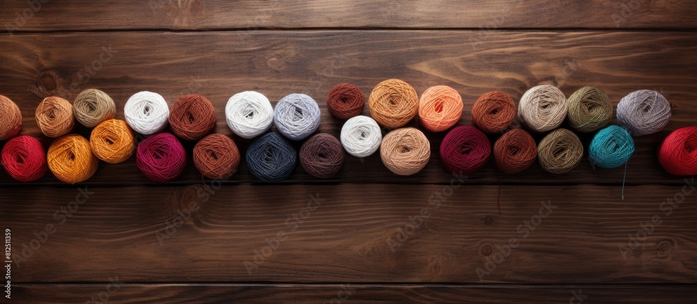Aufkleber top view of knitting threads on a wooden brown table with spokes the image offers copy space