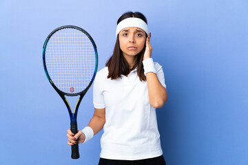 Young woman tennis player over isolated background frustrated and covering ears