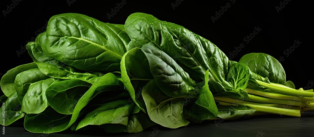 Poster a vibrant image of fresh green spinach set against a dark black background creating ample copy space