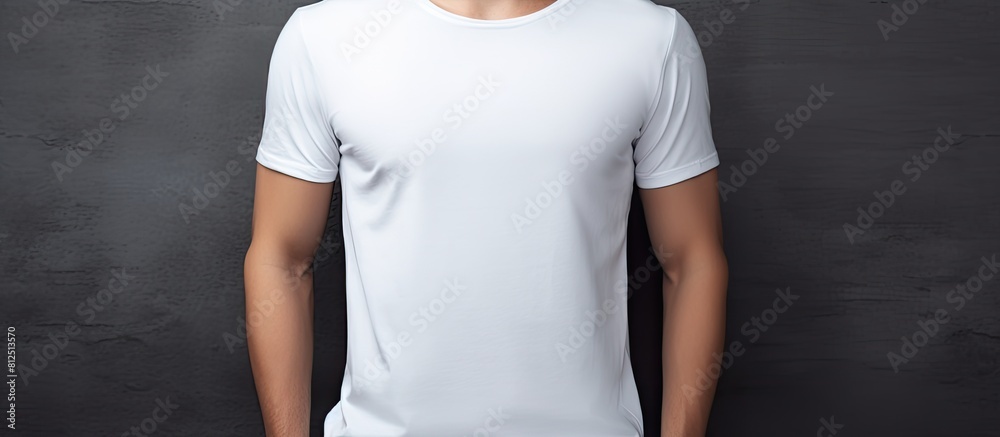 Poster stylish young man wearing a white t shirt poses on a grey background creating a perfect copy space i