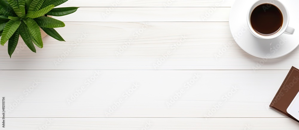 Leinwandbilder on a white office desk there is a top view of a blank notepad laptop coffee cup and potted plant the