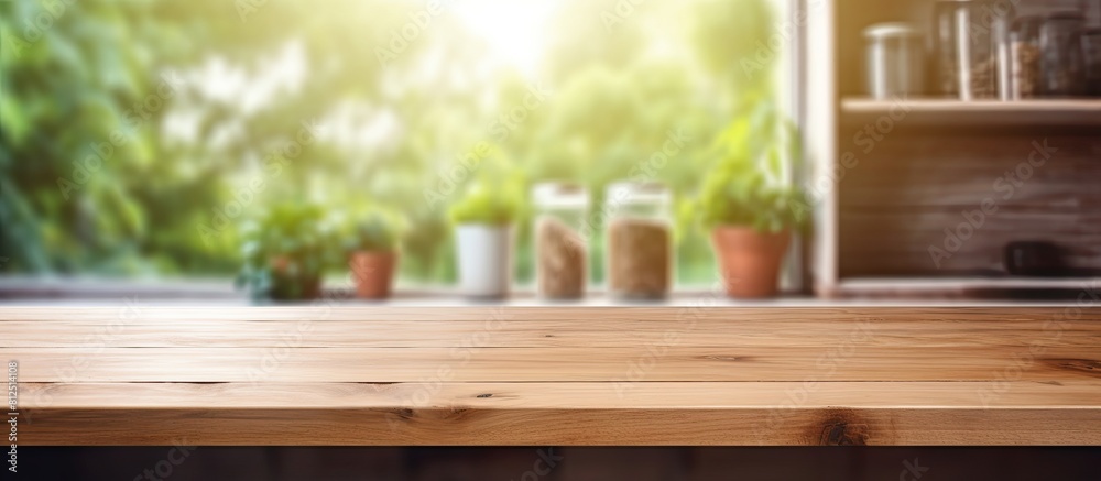 Poster A wooden table with a copy space image stands in front of a blurred background featuring a kitchen window and shelves