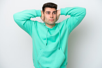 Young caucasian man isolated on white background frustrated and covering ears