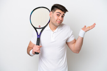young tennis player man isolated on white background having doubts while raising hands