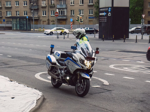 Portrait of russian policeman near his motorbike in the street
