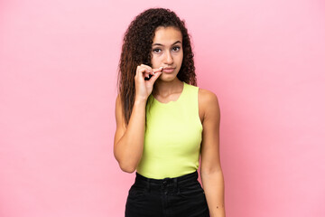 Young hispanic woman isolated on pink background showing a sign of silence gesture