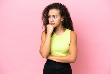 Young hispanic woman isolated on pink background with tired and bored expression