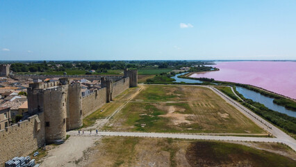 Fototapeta premium Fortified city of Aigues-Mortes, in Provence in France. Entirely surrounded by an imposing city wall and purple salt pans of incredible beauty, Aigues-Mortes is a jewel, an enchanting medieval village