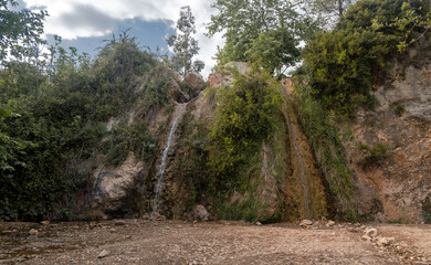 Small double waterfalls photographed from low angle somewhere in the Attica area -Greece.