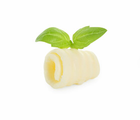 One tasty butter curl and basil leaves isolated on white