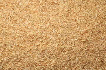 Dry natural sawdust as background, top view