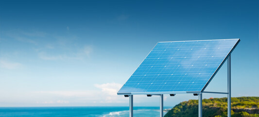 A solar panel on a clear day with a blue sky and ocean in the background, illustrating renewable...