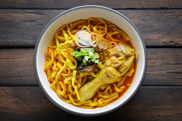Thai food,Khao Soi Recipe,Khao Soi,Khao Soi Kai, Thai Noodles Khao Soi, Chicken Curry with seasoning on wooden floor, Northern Thai food concept. (Lanna food)