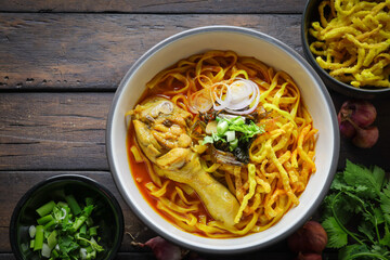Thai food,Khao Soi Recipe,Khao Soi,Khao Soi Kai, Thai Noodles Khao Soi, Chicken Curry with seasoning on wooden floor, Northern Thai food concept. (Lanna food)