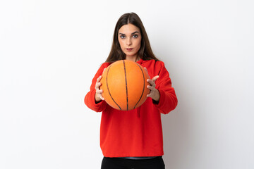 Young caucasian woman isolated on white background playing basketball