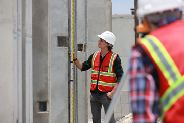A civil engineer or construction engineer is using a survey camera. An engineer who specializes in...
