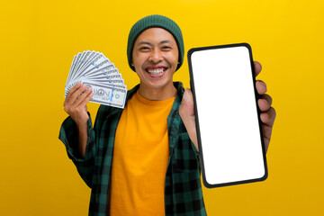Asian man wearing a beanie hat and casual clothes showing his phone at camera with white blank...