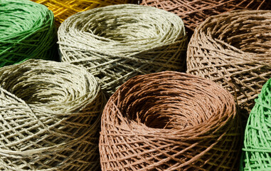 Rolls of colored raffia close-up. Skeins of multi-colored raffia. Eco material for handmade.