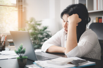 Stressed businesswoman, dealing with the pressures of work and the weight of depression, finds herself struggling in the office, feeling sleepy and overwhelmed by the demands of her job.