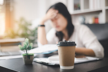 Stressed businesswoman, dealing with the pressures of work and the weight of depression, finds...