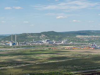 industrial zone. panorama with the village behind. shipyard with containers.