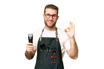 Barber man in an apron over isolated chroma key background showing ok sign with fingers
