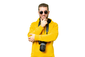 Young photographer man over isolated chroma key background with glasses and smiling