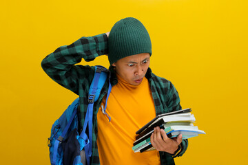 Startled young Asian student, dressed in a beanie hat and casual shirt, carrying a backpack, shows...