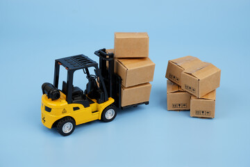 Many carton boxes and yellow forklift truck. 