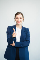 Successful young female businessman giving victory thumbs up to show success and motivation.