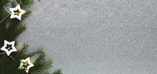 Christmas Silver Textured Background With Pine Branches And Star Lights Decorative Close Up