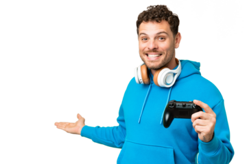 Brazilian man playing with a video game controller over isolated chroma key background extending hands to the side for inviting to come