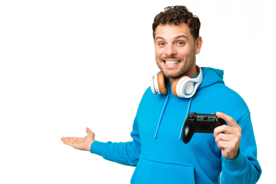 Brazilian man playing with a video game controller over isolated chroma key background extending hands to the side for inviting to come - Powered by Adobe