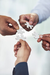 Teamwork, hands and business people with puzzle for unity or collaboration with joint effort for...