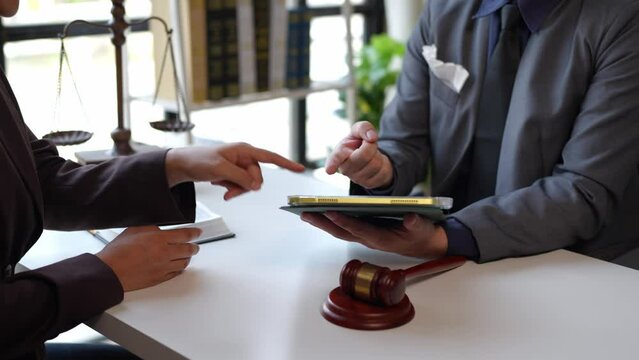Lawyers provide legal advice and chat with clients via online tablets to clarify and give advice on the rules in contract documents that must be followed at the company correctly and fairly.