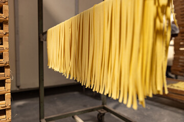 Fresh pasta drying on racks