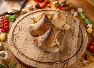 Delicious calzones on a wooden board