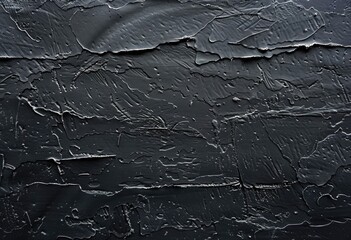 A close up of a dark, liquid texture resembling water on a black background