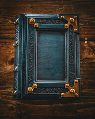 Weathered blue leather book lay down to wooden table