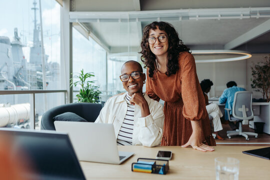 Successful collaboration between diverse business women in a modern boardroom