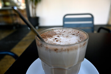 Indulge in Decadence: Close-Up Shot Capturing the Creamy Froth atop a Rich Chocolate Milkshake - Tempting Sips Await in Every Velvety Swirl