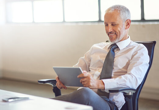 CEO, smile and tablet with corporate man in office for email communication, management or research. Business, internet and technology with happy mature boss or employer reading info in workplace