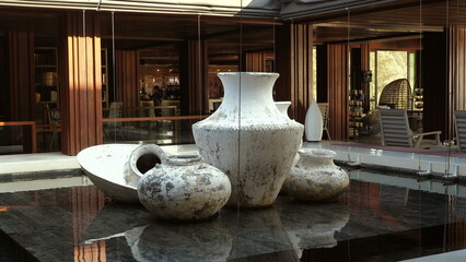 Large ceramic vases with ancient traditional design displayed outdoors as decorative element in luxury hotel, reflecting cultural heritage and sophisticated ambience. Art in architecture and design.