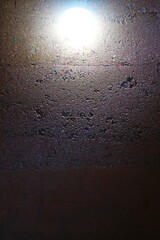 Background of the rammed earth wall with light bulb.