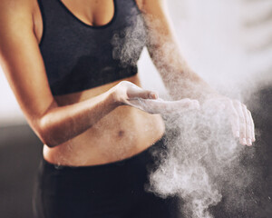 Woman, fitness and person with powder on hands, gym chalk and weightlifting preparation for exercise. Body builder, sport and training class for competition, help with grip on health equipment